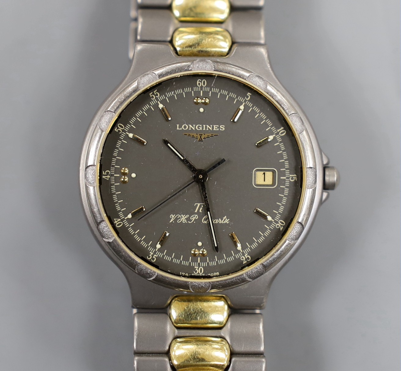 A gentleman's modern steel? and gold plated Longines TI VHP Quartz wristwatch, with box and some papers.